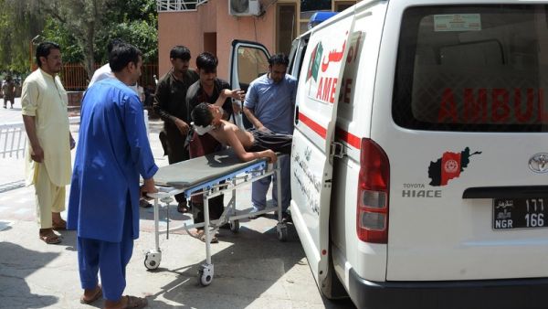 Afghan volunteers carry an injured youth on a stretcher to a hospital following an attack that targeted an education department on July 11, 2018. (AFP/ File)