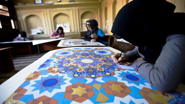 Young women work on geometric designs and calligraphy art at Turquoise Mountain Institute. (Courtesy Turquoise Mountain)