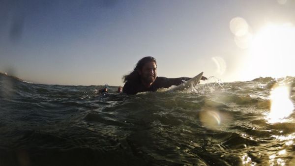 Afghan surfer Afridun Amu paddles out to catch a wave in preparation for the World Surfing Games in Biarritz. (AFP/File)