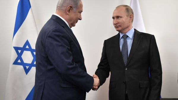 Israeli Prime Minister Benjamin Netanyahu, left, greets Russian President Vladimir Putin. (AFP/File)