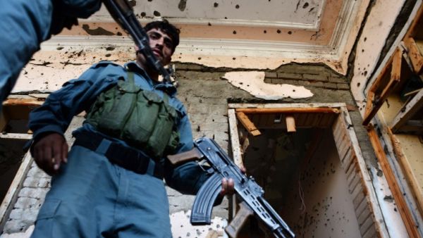 Afghan security forces inspect the site of a suicide bombing that targeted a gathering of the local tribal elders in Chaparhar district of Nangarhar province on October 31, 2016.(AFP/Noorullah Shirzada)
