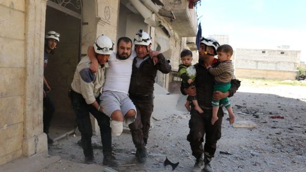 Volunteers evacuate a man and child following an airstrike in rebel-held eastern Aleppo. (AFP/Ameer Alhalbi)