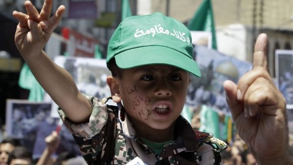 A boy wearing a cap reading in Arabic: '"We are all resistant" takes part in a demonstration by Jordan's Muslim Brotherhood (AFP/File)