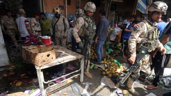 Iraqi security forces gather at the site of a suicide bombing in the Shaab area in northern Baghdad on May 17, 2016. (AFP/Getty/File) 