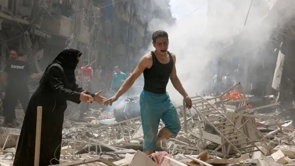 People walk amid the rubble of destroyed buildings in Aleppo. (AFP/File) 