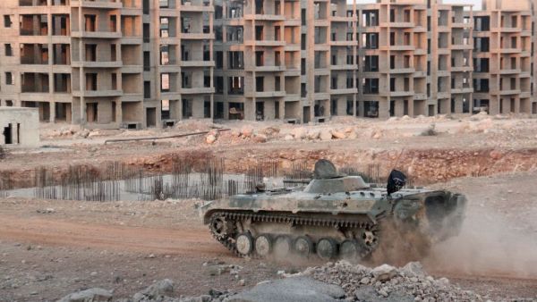 Opposition fighters drive a tank in an eastern government sieged neighbourhood of Aleppo as jihadists and their rebel allies pressed an offensive on August 5, 2016. (AFP/Omar Haj Kadour)