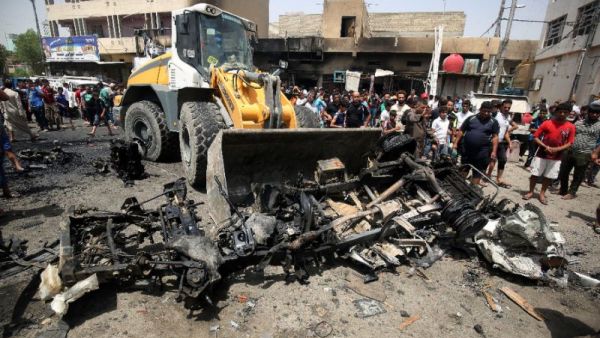 A bulldozer clears the wreckage following a car bomb attack in Sadr City, a Shiite area north of the capital Baghdad, on May 11, 2016. (AFP/Agmad Al Rubaye)