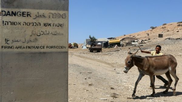A sign on a concrete block reads "Firing area entrance forbidden" in Hebrew, Arabic and English (AFP/Jaafar Ashtiyeh)