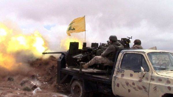 A Hezbollah fighter fires towards Syrian rebel areas on the Syrian side of the Qalamun hills close to the Lebanese border on May 16, 2015. (AFP/File) 
