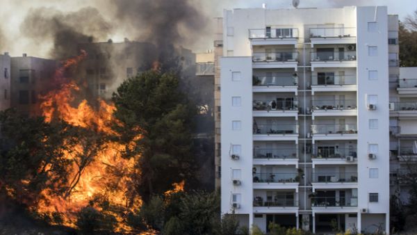 Fire threatens to engulf a tower block in Haifa, Israel. (AFP)