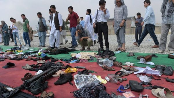 Relatives and friends inspect shoes and other belongings of those who were killed in the twin suicide attack, gathered on the ground at a mosque in Kabul on July 24, 2016. (AFP/Shah Marai) 