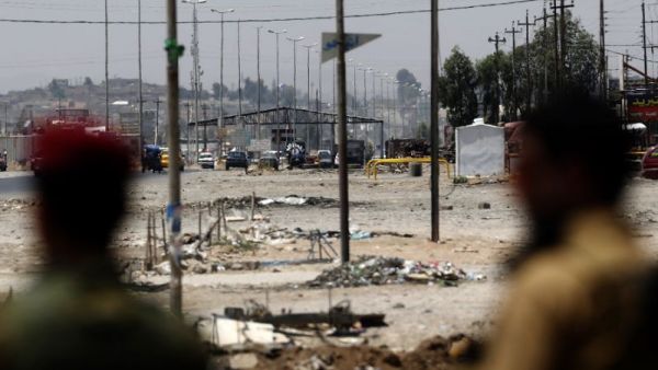 Kurdish Peshmerga forces look at a checkpoint held by Islamic State militants in Iraq's second city of Mosul. (AFP/Karim Sahib)