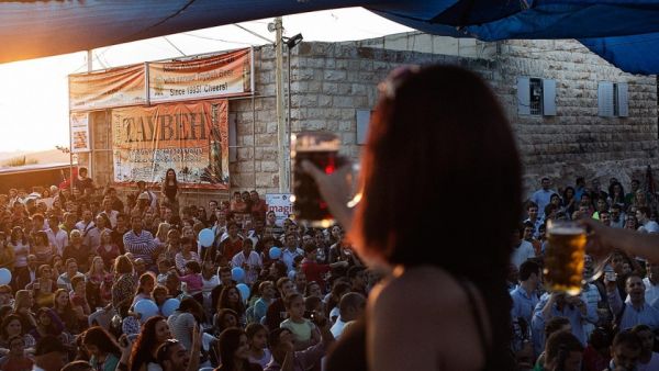 Palestinians and foreign visitors gather at the 2012 Taybeh Oktoberfest beer festival in the West Bank Christian village of Taybeh, near Ramallah. (AFP/Marco Longari)  