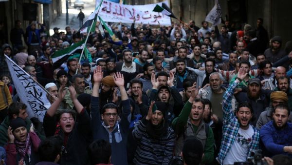 Anti-regime protesters take advantage of the ceasefire to stage a protest in a rebel-held neighborhood of Aleppo. (AFP/Karam Al-Masri)