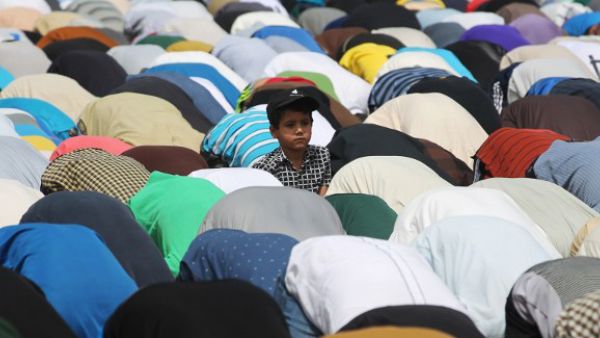 An Iraqi boy looks on as supporters of Shiite cleric Moqtada al-Sadr attend Friday prayers in Baghdad's Sadr City. (AFP/File)