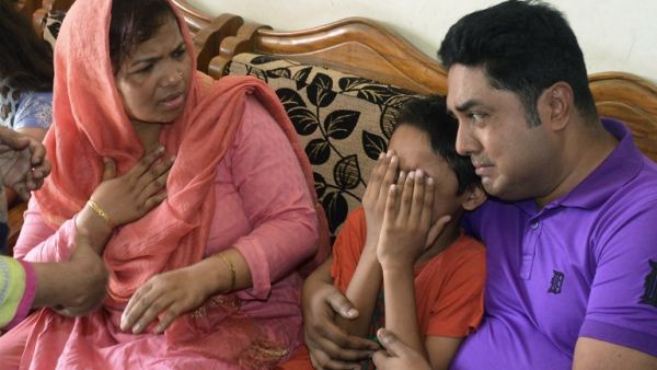 The young son of Mahmuda Aktar, the wife of a top Bangladeshi anti-terror officer, mourns after she was shot dead near her home in Chittagong on June 5, 2016. (AFP/