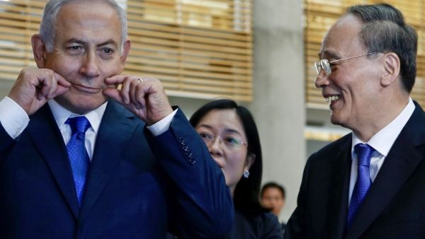 Chinese Vice President Wang Qishan (R) laughs as Israeli Prime Minister Benjamin Netanyahu (L) makes a face during their tour of the Israeli Innovation Summit in Jerusalem on October 24, 2018. (AFP/File)