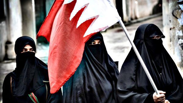 Bahraini activists holding the national flag. (AFP/File)