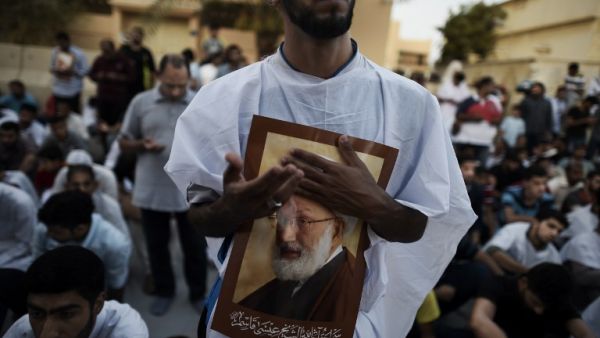 Bahraini protesters hold posters of Sheikh Qassim in June, after Bahraini authorities stripped him of his citizenship. (AFP/File)