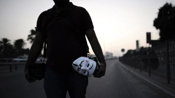 An anti-regime protester walks the streets in Bahrain. (AFP/File)