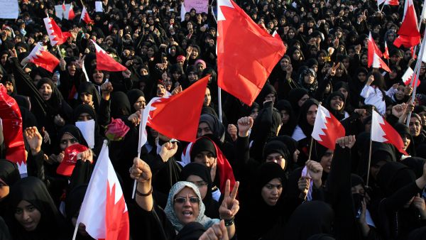 People wave Bahraini flags during a demonstration. (AFP/File)