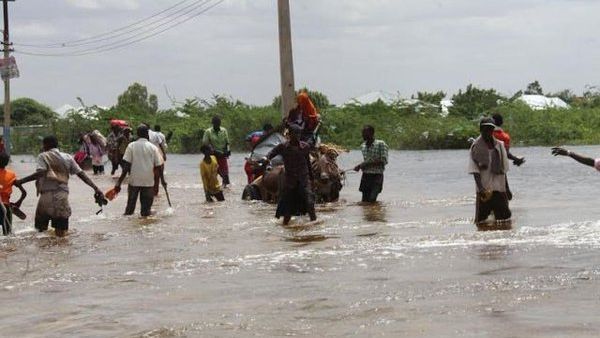 Residents in Beledweyne, Somalia, walk through the flood waters. (Twitter)