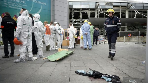 Forensic investigators gather around a blood-soaked vest outside the Brussels airport. (AFP/Yorick Jansens)