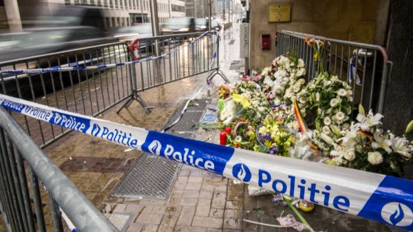 A photo taken on March 25, 2016 shows wreaths of flowers in front of an entrance of the Maalbeek subway station in Brussels in homage to the victims of Tuesday's attack.  (AFP/Philippe Huguen)