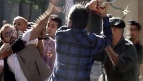 A Lebanese customs official attacks a reporter with his own bullhorn. (YouTube)