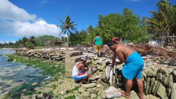 Residents of Kiribati attempt to block the rising tide with stone walls. (File)