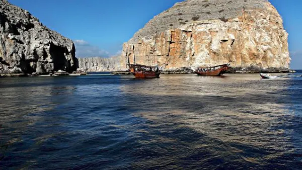 Dhows carrying tourists cruise off the Oman's Khasab shores along the Strait of Hormuz. (AFP/File)