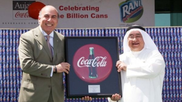 Sheikh Adel Aujan (right), chairman, Aujan Group Holding, and Muhtar Kent, chairman and CEO, The Coca-Cola Company, celebrate the billionth can of Rani produced under their partnership. (Coca-Cola)