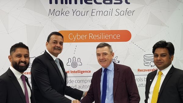 Spire Solution's Sanjeev Walia shakes hands with Mimecast's Jeff Ogden