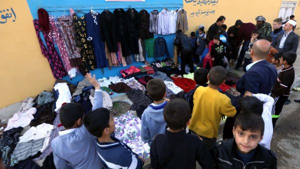 People line up to try on clothes at the Charity Wall in Erbil. (AFP/Safin Hamed)