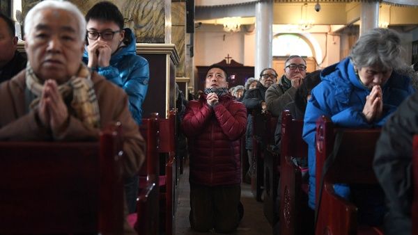 Chinese Christians pray in a state-backed church (AFP/FILE)
