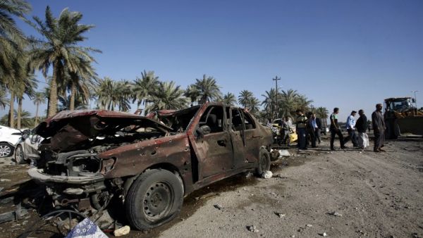 People examine the debris after a truck bomb exploded at a checkpoint in Hilla. (AFP/Haidar Hamdani)