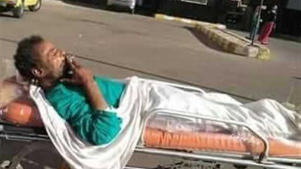 widespread photos of a patient who was allowed to smoke a cigarette, while being moved in a trolley on hospital grounds in Egypt. (Twitter)