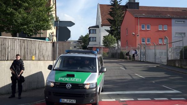A pliceman stands near a migrant reception center on July 27, 2016 in Zirndorf, southern Germany, following an explosion of a suitcase. (AFP/Daniel Karmann)