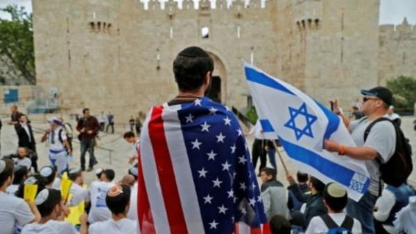 اسرائيلي يلف نفسه بعلم أميركي في المدينة القديمة في القدس

