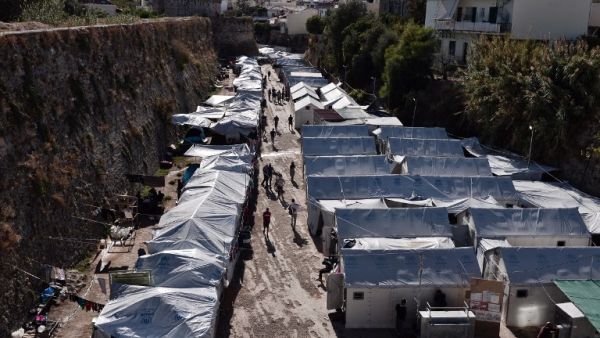 People walk at the Souda municipality-run refugee camp, on the island of Chios on October 13, 2016. (AFP/Louisa Gouliamaki)