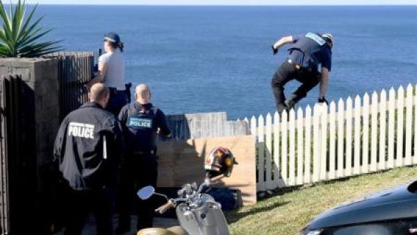 رجل شرطة أثناء أحدى المداهمات ضد المخدرات في سيدني يوم الثلاثاء-صورة لرويترزملحوظة
