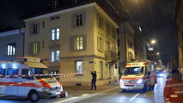 Ambulance and police cars are seen outside a Muslim prayer hall, central Zurich, on December 19, 2016, after three people were injured by gunfire. (AFP/Michael Buholzer)