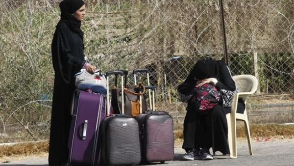 Palestinians wait near their luggage at the Rafah border terminal in the southern Gaza Strip before crossing into neighbouring Egypt on August 24, 2013. AFP PHOTO SAID KHATIB Palestinians wait near their luggage at the Rafah border terminal in the southern Gaza Strip before crossing into neighbouring Egypt on August 24, 2013. AFP PHOTO SAID KHATIB