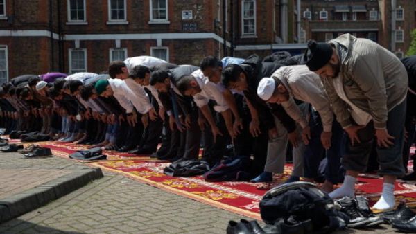Muslims attend Friday prayers in the sunshine at the BBC Community Centre in the Spitalfields area, London, UK (Getty)
