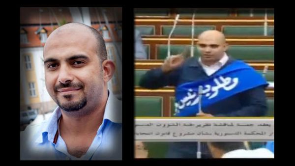 Abdulrahman Huraidi wearing a blue sash labeled “a new president is needed.” (Al Arabiya English screenshot)