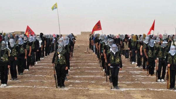 A picture taken on July 18, 2013 shows Kurdish opposition fighters attending a ceremony the northern Syrian border village of al Qamishli (AFP/STR)