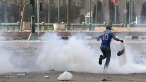 Egyptian runs through tear gas during the 2011 uprising