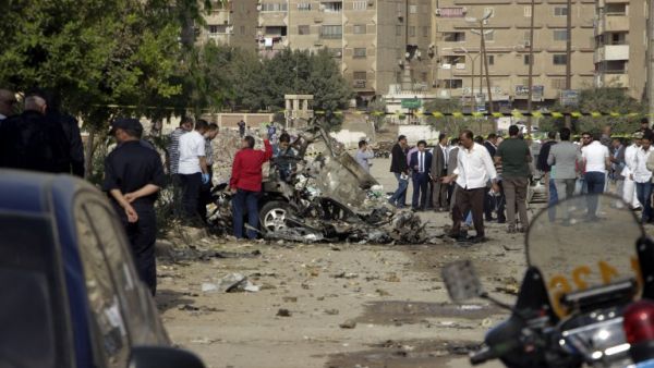 Egyptian policemen inspect the wreckage of a car after a bomb exploded in the eastern Nasr City district of the Egyptian capital Cairo on November 4, 2016. (AFP/Suhail Saleh)