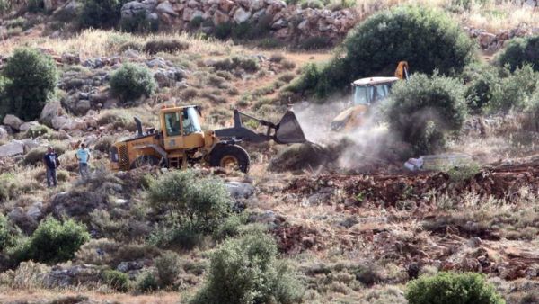 Bulldozers clear land for a new settlement in the West Bank village of Wadi Fukin. ( AFP/File)