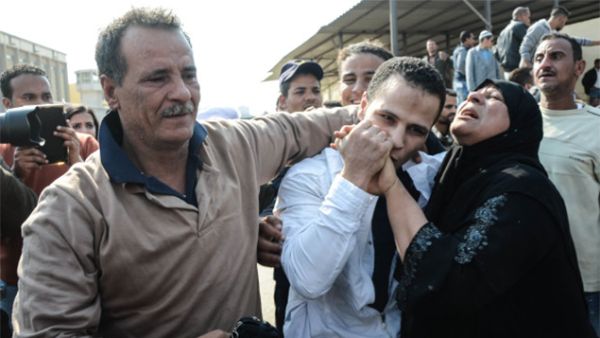 An Egyptian man embraces his parents following his release from prison in Cairo on March 14, 2017, along with 202 other prisoners who received a presidential pardon. (AFP)